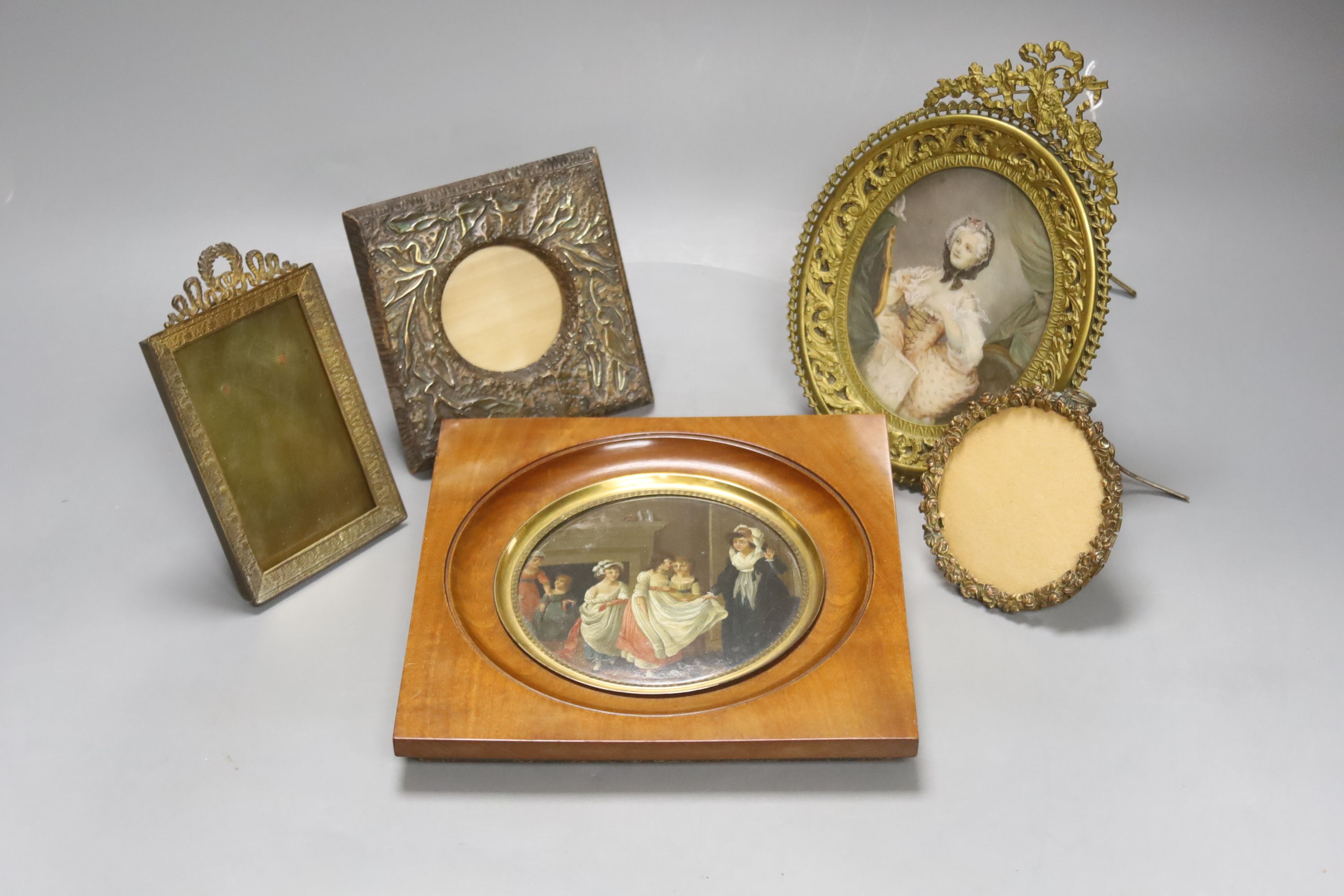 A Victorian framed miniature (snuff box lid) of children in a nursery, another miniature and three small frames, largest 10cm diameter